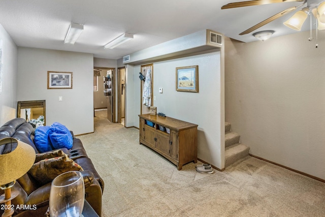 interior space featuring ceiling fan and light carpet