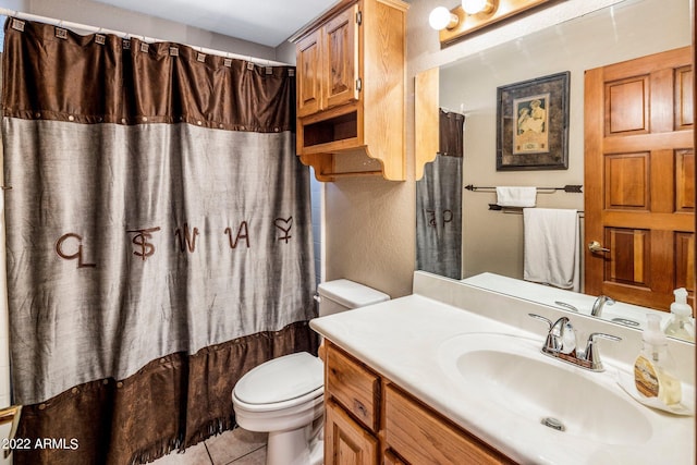 bathroom featuring toilet, tile patterned floors, and vanity