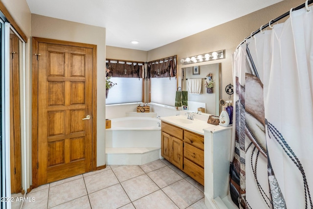 bathroom featuring tile patterned floors, vanity, and shower with separate bathtub