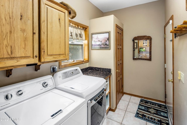 washroom featuring light tile patterned flooring, cabinets, and washer and dryer