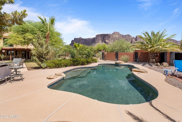 view of swimming pool with a mountain view and a patio