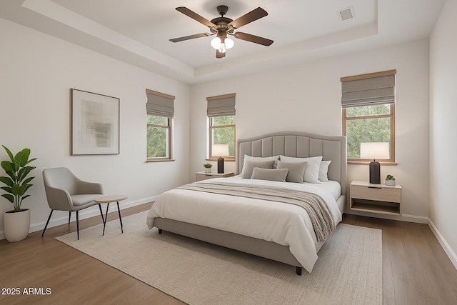 3438 W Little Hopi Dr, Phoenix, AZ 85086 - bedroom with a tray ceiling, wood finished floors, baseboards, and a ceiling fan