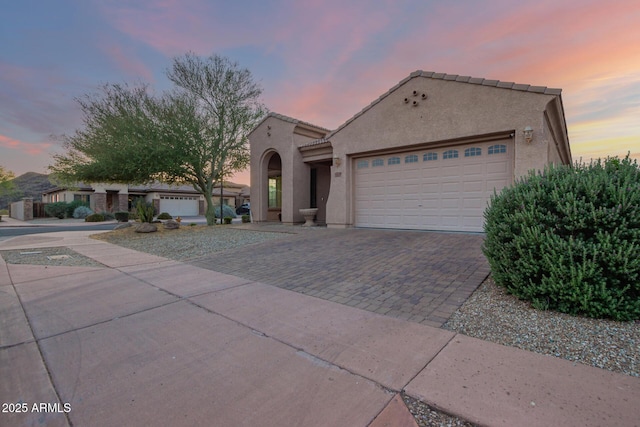 3438 W Little Hopi Dr, Phoenix, AZ 85086 - mediterranean / spanish home featuring stucco siding, an attached garage, driveway, and a tile roof