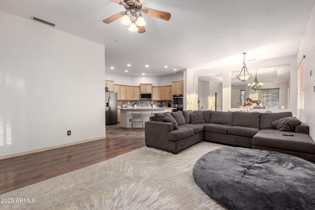 3438 W Little Hopi Dr, Phoenix, AZ 85086 - living area with light wood-type flooring, a ceiling fan, a chandelier, recessed lighting, and baseboards