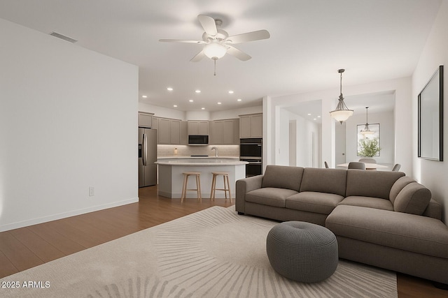 3438 W Little Hopi Dr, Phoenix, AZ 85086 - living area featuring dark wood-style floors, a ceiling fan, recessed lighting, and baseboards