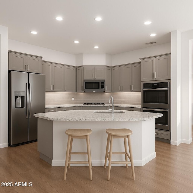 3438 W Little Hopi Dr, Phoenix, AZ 85086 - kitchen with appliances with stainless steel finishes, a sink, gray cabinets, light wood-type flooring, and recessed lighting