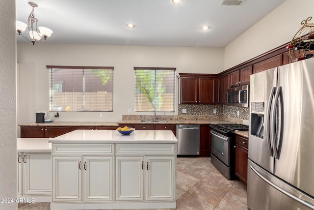 kitchen with appliances with stainless steel finishes, tasteful backsplash, plenty of natural light, and sink