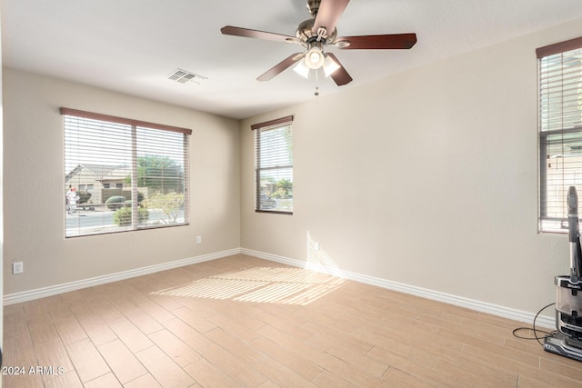 spare room featuring light hardwood / wood-style floors and ceiling fan