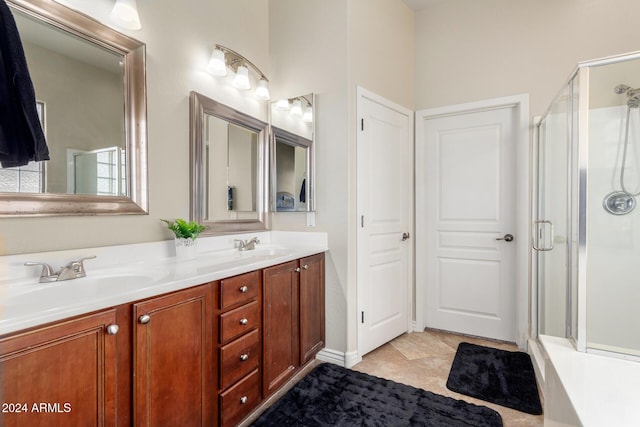 bathroom featuring tile patterned flooring, vanity, and a shower with door