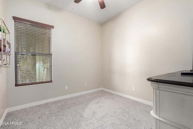 carpeted empty room featuring ceiling fan