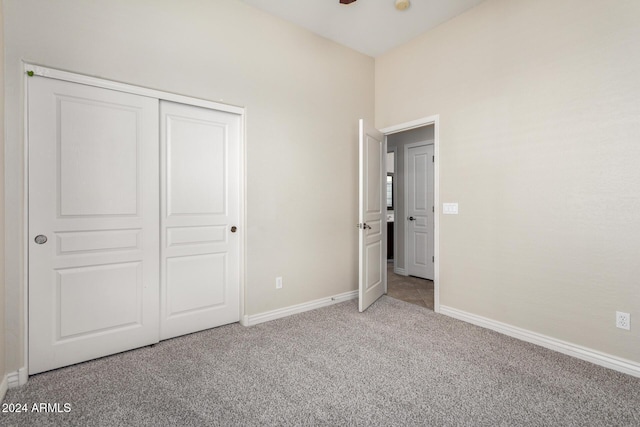 unfurnished bedroom with carpet floors and a closet