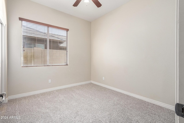 carpeted empty room featuring ceiling fan