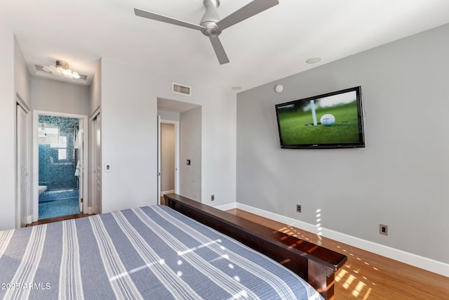 15221 N Clubgate Dr Unit 2059, Scottsdale, AZ 85254 - unfurnished bedroom with baseboards, wood finished floors, ceiling fan, and connected bathroom