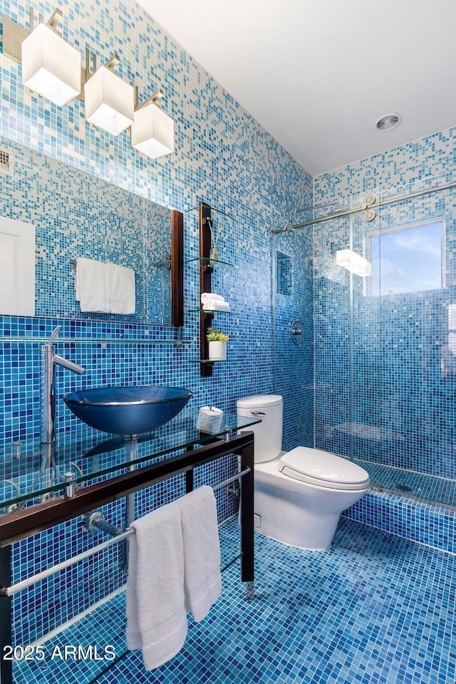 15221 N Clubgate Dr Unit 2059, Scottsdale, AZ 85254 - full bathroom featuring a shower stall, toilet, tile walls, and tile patterned floors