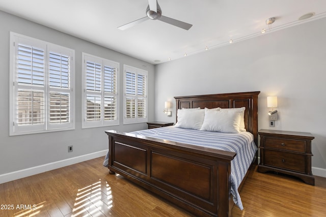 15221 N Clubgate Dr Unit 2059, Scottsdale, AZ 85254 - bedroom with baseboards, wood finished floors, and ceiling fan