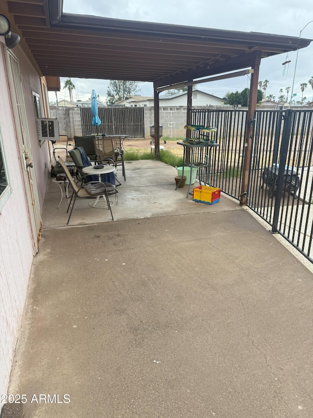 view of patio / terrace featuring cooling unit and fence