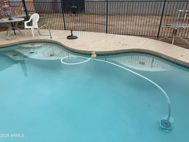 view of pool featuring fence