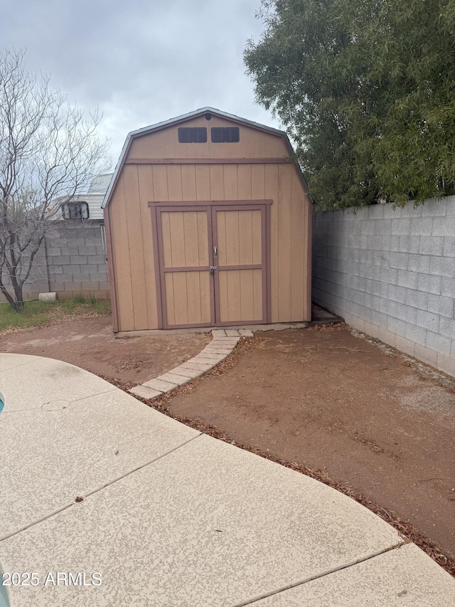 view of shed with a fenced backyard