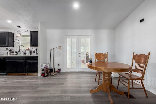 dining room with recessed lighting, french doors, visible vents, and light wood-style flooring
