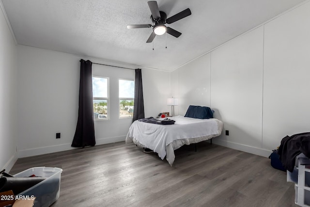 bedroom featuring baseboards, a ceiling fan, and wood finished floors