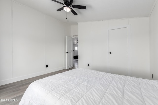 bedroom with ceiling fan and wood finished floors