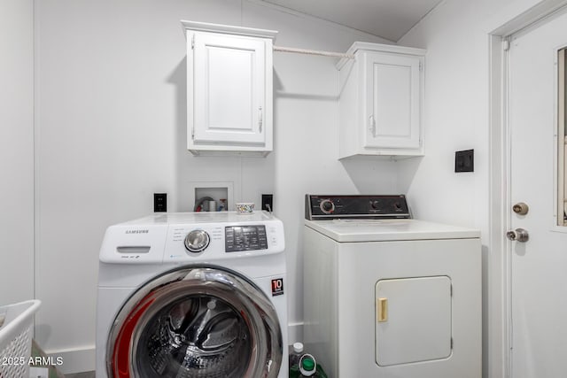 laundry area featuring cabinet space and washing machine and clothes dryer