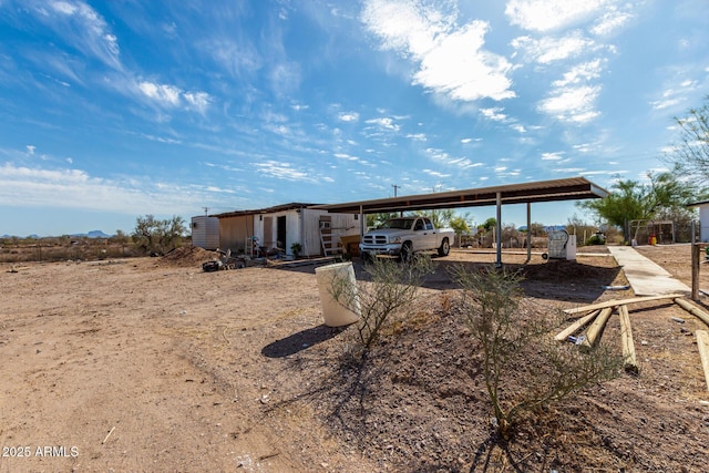 exterior space with an outdoor structure and a carport