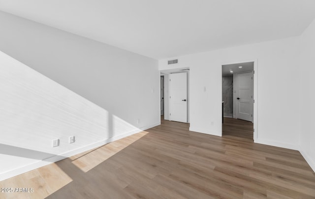 empty room featuring wood-type flooring