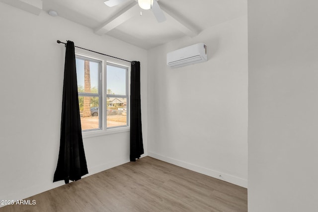 unfurnished room with light wood-type flooring, a wall unit AC, plenty of natural light, and ceiling fan