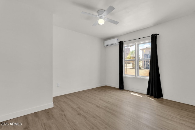 unfurnished room featuring an AC wall unit, ceiling fan, and light hardwood / wood-style flooring