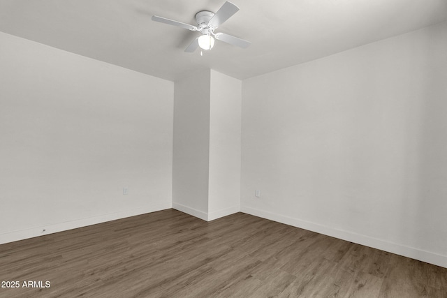 unfurnished room with ceiling fan and dark hardwood / wood-style flooring