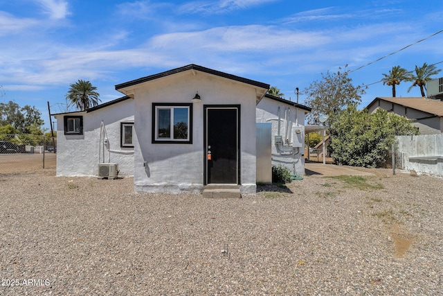 rear view of property with central AC