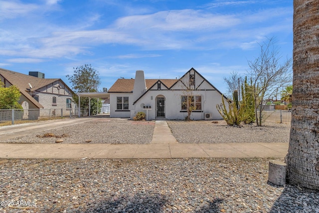 english style home featuring a carport