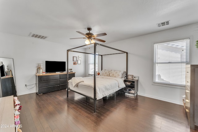 bedroom with multiple windows, ceiling fan, and dark hardwood / wood-style flooring