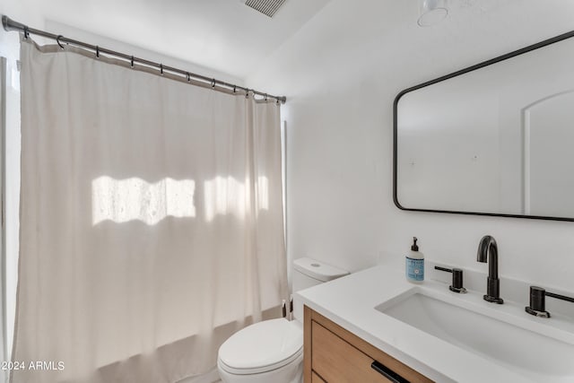 full bathroom featuring shower / bath combination with curtain, vanity, and toilet