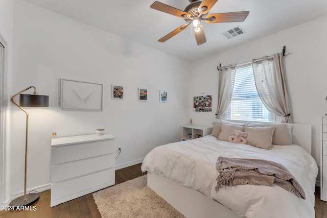 bedroom with ceiling fan and dark hardwood / wood-style flooring