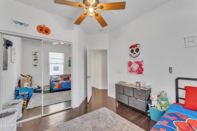 bedroom with a closet, dark hardwood / wood-style floors, vaulted ceiling, and ceiling fan