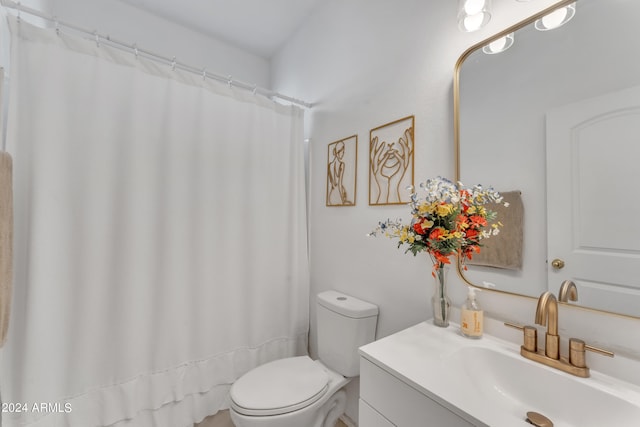 bathroom with walk in shower, vanity, and toilet