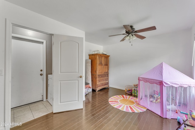 playroom with wood-type flooring and ceiling fan