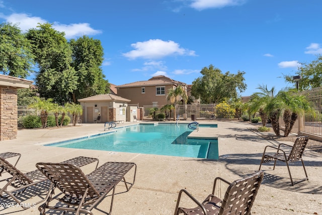 view of pool featuring an outbuilding and a patio area