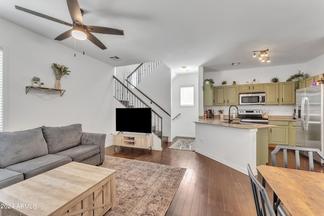 living room featuring dark hardwood / wood-style floors, sink, and ceiling fan