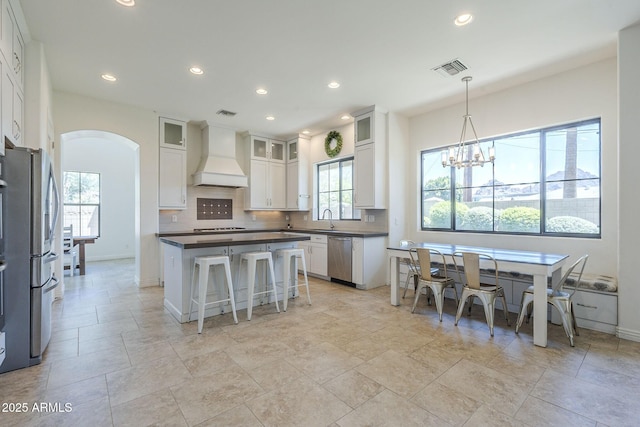 3812 E Camelback Rd, Phoenix, AZ 85018 - kitchen with custom exhaust hood, arched walkways, appliances with stainless steel finishes, plenty of natural light, and recessed lighting
