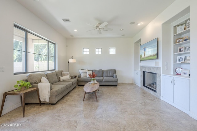 3812 E Camelback Rd, Phoenix, AZ 85018 - living area featuring a tile fireplace, built in features, a ceiling fan, recessed lighting, and baseboards