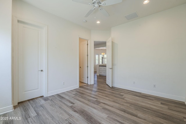 3812 E Camelback Rd, Phoenix, AZ 85018 - unfurnished bedroom featuring wood finished floors, baseboards, recessed lighting, and a ceiling fan