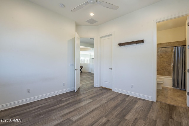 3812 E Camelback Rd, Phoenix, AZ 85018 - unfurnished bedroom featuring wood finished floors, baseboards, connected bathroom, and a ceiling fan