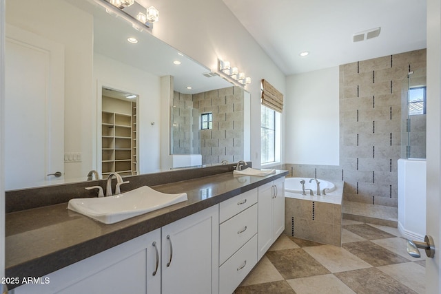 3812 E Camelback Rd, Phoenix, AZ 85018 - bathroom with a stall shower, plenty of natural light, a garden tub, and recessed lighting