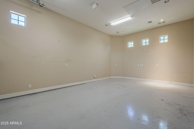 3812 E Camelback Rd, Phoenix, AZ 85018 - spare room with concrete floors, healthy amount of natural light, and baseboards