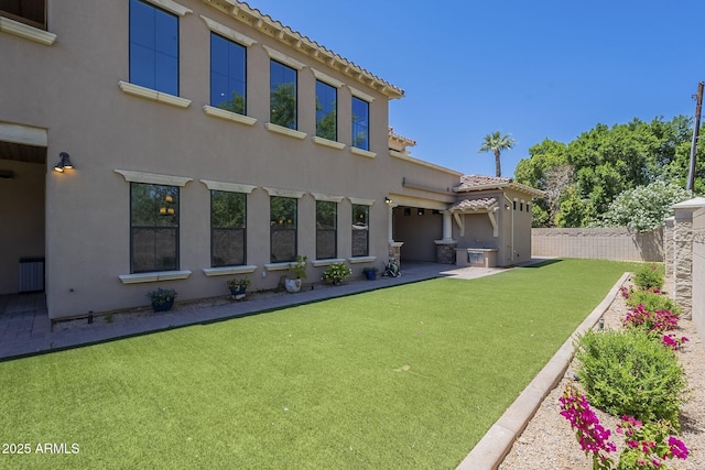 3812 E Camelback Rd, Phoenix, AZ 85018 - rear view of house with stucco siding, a fenced backyard, a tiled roof, and a patio