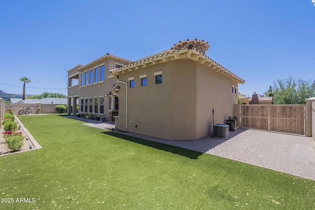 3812 E Camelback Rd, Phoenix, AZ 85018 - back of house with stucco siding, a patio area, a tiled roof, and central air condition unit