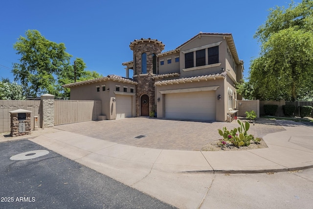 3812 E Camelback Rd, Phoenix, AZ 85018 - mediterranean / spanish house featuring stucco siding, driveway, a tiled roof, a gate, and a garage